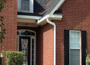 Brick home with a white gutter system