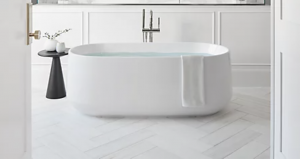 White bathroom with an oval, white, free-standing tub
